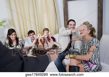 Young woman celebrating a birthday party with her friends View Large Photo Image Stock Photo - Young woman celebrating a birthday party with her friends. Fotosearch