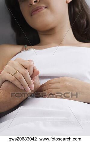 Young woman holding a man's hand View Large Photo Image Stock Image - Young woman holding a man's hand. Fotosearch