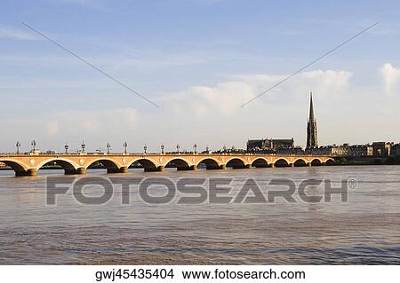 Arch bridge across a river, Pont De Pierre, St. Michel Basilica, Garonne River, Bordeaux, Aquitaine, France View Large Photo Image Picture - Arch bridge across a river, Pont De Pierre, St. Michel Basilica, Garonne River, Bordeaux, Aquitaine, France. Fotosearch