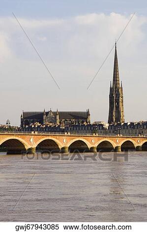 Arch bridge across a river, Pont De Pierre, St. Andre Cathedral, Garonne River, Bordeaux, Aquitaine, France View Large Photo Image Stock Photography - Arch bridge across a river, Pont De Pierre, St. Andre Cathedral, Garonne River, Bordeaux, Aquitaine, France. Fotosearch