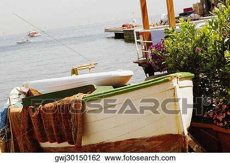 Stock Image - Boat moored at the seaside, Marina Grande, Capri, Sorrento, Sorrentine Peninsula, Naples Province, Campania, Italy. Fotosearch