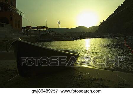 Boat on the beach at dusk, Italian Riviera, Cinque Terre National Park, Il Porticciolo, Vernazza, La Spezia, Liguria, Italy View Large Photo Image Stock Photo - Boat on the beach at dusk, Italian Riviera, Cinque Terre National Park, Il Porticciolo, Vernazza, La Spezia, Liguria, Italy. Fotosearch