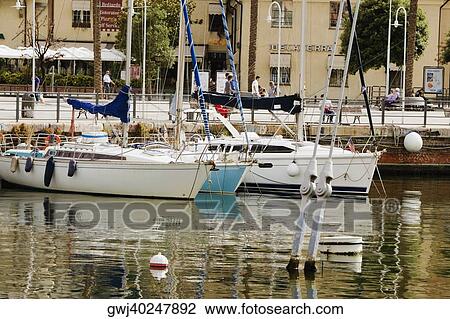 Boats at a harbor, Porto Antico, Genoa, Liguria, Italy View Large Photo Image Stock Image - Boats at a harbor, Porto Antico, Genoa, Liguria, Italy. Fotosearch