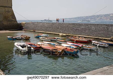 Stock Photo - Boats docked at a harbor, Borgo Marinaro, Castel Dell'ovo, Bay of Naples, Naples, Naples Province, Campania, Italy. Fotosearch