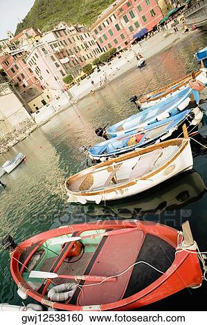 Stock Image - Boats docked at a port, Italian Riviera, Cinque Terre National Park, Piazza Marconi, Il Porticciolo, Vernazza, La Spezia, Liguria, Italy. Fotosearch