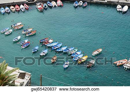 Boats docked at harbor, Italian Riviera, Cinque Terre National Park, Il Porticciolo, Vernazza, La Spezia, Liguria, Italy View Large Photo Image Stock Photo - Boats docked at harbor, Italian Riviera, Cinque Terre National Park, Il Porticciolo, Vernazza, La Spezia, Liguria, Italy. Fotosearch