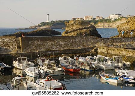 Boats moored at a port, Port Des Pecheurs, Baie De Biarritz, Phare De Biarritz, Biarritz, France View Large Photo Image Stock Image - Boats moored at a port, Port Des Pecheurs, Baie De Biarritz, Phare De Biarritz, Biarritz, France. Fotosearch