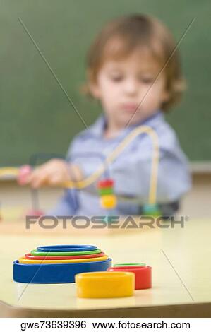 Boy playing with a buzz wire game View Large Photo Image Stock Photograph - Boy playing with a buzz wire game. Fotosearch