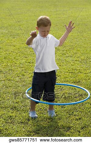 Boy playing with a plastic hoop View Large Photo Image Stock Image - Boy playing with a plastic hoop. Fotosearch