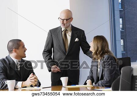 Business executives discussing in a board room View Large Photo Image Picture - Business executives discussing in a board room. Fotosearch