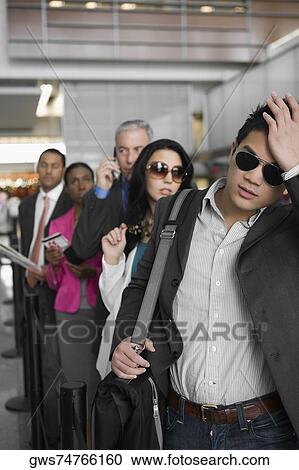 Business executives standing in a row at an airport View Large Photo Image Stock Image - Business executives standing in a row at an airport. Fotosearch
