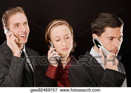 Business executives talking on mobile phones View Large Photo Image Stock Photo - Business executives talking on mobile phones. Fotosearch