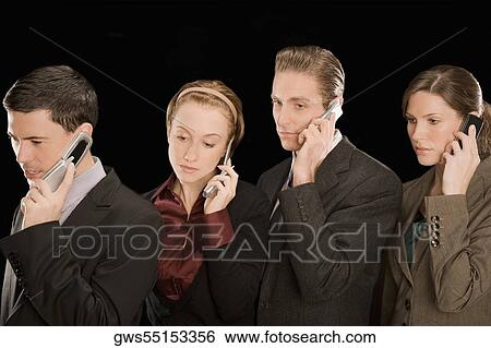 Business executives talking on mobile phones View Large Photo Image Stock Photograph - Business executives talking on mobile phones. Fotosearch
