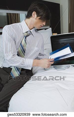 Businessman looking at documents View Large Photo Image Stock Photo - Businessman looking at documents. Fotosearch