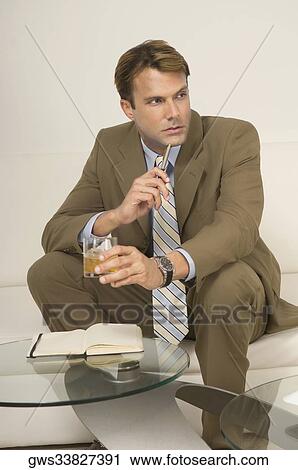 Stock Image - Businessman sitting on a couch. Fotosearch