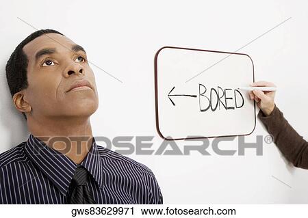 Businessman thinking with a businesswoman's hand writing on the whiteboard View Large Photo Image Stock Image - Businessman thinking with a businesswoman's hand writing on the whiteboard. Fotosearch