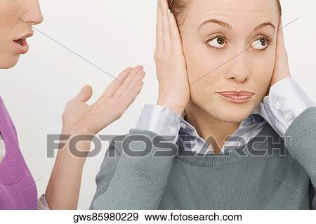 Businesswoman gesturing with her colleague ignoring her View Large Photo Image Stock Photo - Businesswoman gesturing with her colleague ignoring her. Fotosearch