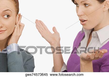 Businesswoman gesturing with her colleague ignoring her View Large Photo Image Stock Photography - Businesswoman gesturing with her colleague ignoring her. Fotosearch