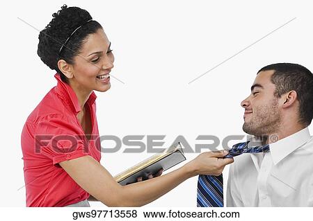 Stock Photo - Businesswoman pulling a businessman with his tie and smiling. Fotosearch