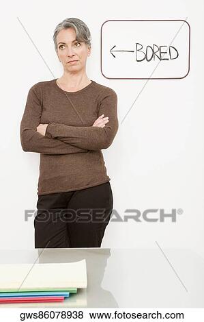 Businesswoman standing with her arms crossed and thinking View Large Photo Image Stock Photo - Businesswoman standing with her arms crossed and thinking. Fotosearch