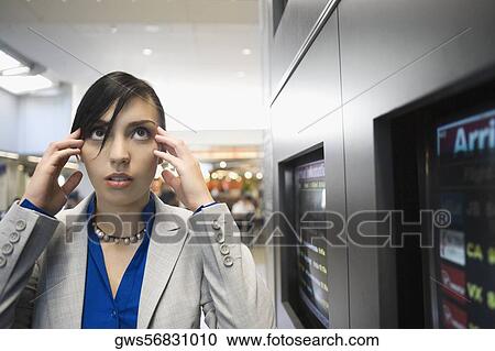 Businesswoman suffering from a headache at an airport View Large Photo Image Stock Image - Businesswoman suffering from a headache at an airport. Fotosearch