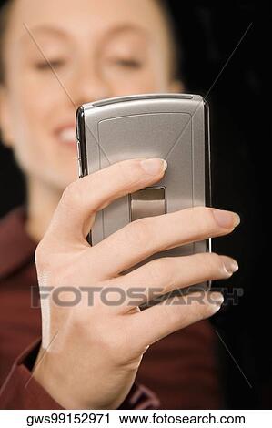 Businesswoman text messaging and smiling View Large Photo Image Stock Image - Businesswoman text messaging and smiling. Fotosearch
