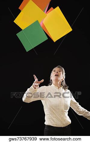Stock Photo - Businesswoman throwing papers in the air. Fotosearch