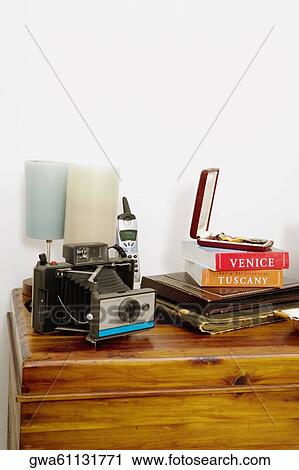 Stock Image - Camera with a lamp on a table. Fotosearch