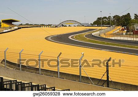 Chain-link fence along with a motor racing tracks in a field, Le Mans, France View Large Photo Image Stock Photo - Chain-link fence along with a motor racing tracks in a field, Le Mans, France. Fotosearch