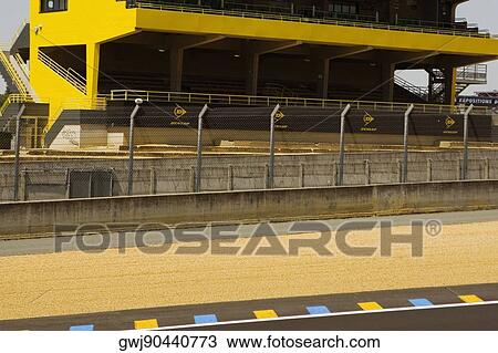 Stock Image - Chain-link fence along with motor racing track, Le Mans, France. Fotosearch