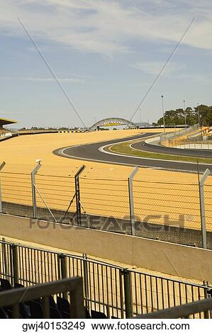 Stock Photo - Chain-link fence along with motor racing tracks in a field, Le Mans, France. Fotosearch