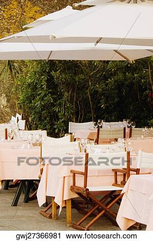 Chairs and tables at a restaurant, Italian Riviera, Portofino, Genoa, Liguria, Italy View Large Photo Image Stock Image - Chairs and tables at a restaurant, Italian Riviera, Portofino, Genoa, Liguria, Italy. Fotosearch