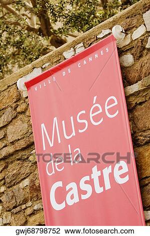 Stock Image - Close-up of a banner hanging on a stone wall, Musee De La Castre, Cote d'Azur, Cannes, Provence-Alpes-Cote D'Azur, France. Fotosearch