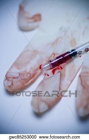 Close-up of a blood syringe with a dirty glove View Large Photo Image Stock Image - Close-up of a blood syringe with a dirty glove. Fotosearch