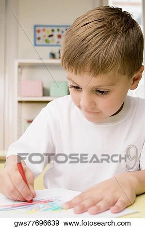 Close-up of a boy drawing on a sheet of paper View Large Photo Image Stock Photo - Close-up of a boy drawing on a sheet of paper. Fotosearch