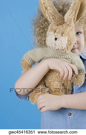 Close-up of a boy hiding his face with a teddy bear View Large Photo Image Stock Image - Close-up of a boy hiding his face with a teddy bear. Fotosearch