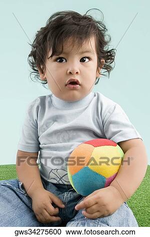 Close-up of a boy holding a ball View Large Photo Image Stock Image - Close-up of a boy holding a ball. Fotosearch
