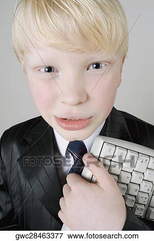Stock Photo - Close-up of a boy holding a computer keyboard. Fotosearch