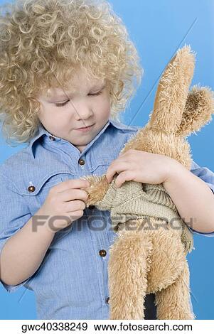Close-up of a boy holding a teddy bear View Large Photo Image Stock Photo - Close-up of a boy holding a teddy bear. Fotosearch