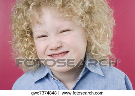 Stock Image - Close-up of a boy making a face. Fotosearch