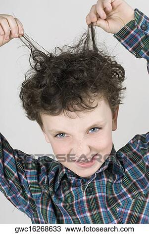 Close-up of a boy pulling his hair View Large Photo Image Stock Image - Close-up of a boy pulling his hair. Fotosearch