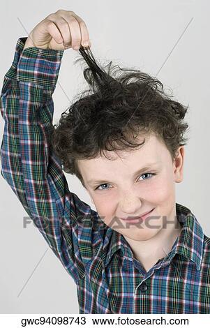 Close-up of a boy pulling his hair View Large Photo Image Stock Image - Close-up of a boy pulling his hair. Fotosearch