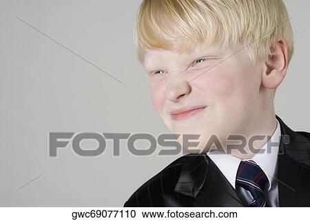 Stock Image - Close-up of a boy smirking. Fotosearch