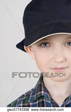 Close-up of a boy wearing a cap View Large Photo Image Stock Photo - Close-up of a boy wearing a cap. Fotosearch