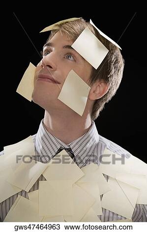 Close-up of a businessman covered with adhesive notes and day dreaming View Large Photo Image Stock Image - Close-up of a businessman covered with adhesive notes and day dreaming. Fotosearch