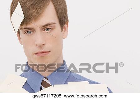 Close-up of a businessman covered with adhesive notes and thinking View Large Photo Image Stock Photography - Close-up of a businessman covered with adhesive notes and thinking. Fotosearch