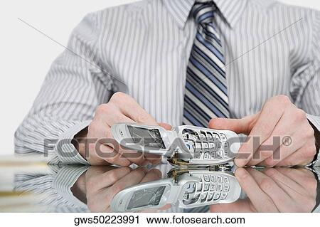Close-up of a businessman holding a broken mobile phone View Large Photo Image Stock Image - Close-up of a businessman holding a broken mobile phone. Fotosearch