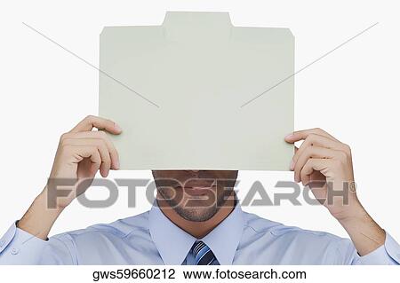 Close-up of a businessman holding a placard in front of his face View Large Photo Image Stock Image - Close-up of a businessman holding a placard in front of his face. Fotosearch