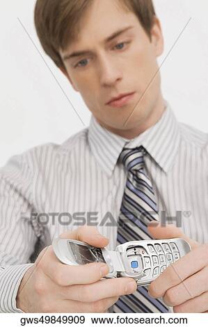 Close-up of a businessman holding a broken mobile phone View Large Photo Image Stock Photo - Close-up of a businessman holding a broken mobile phone. Fotosearch
