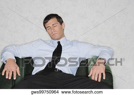 Close-up of a businessman napping in an armchair View Large Photo Image Picture - Close-up of a businessman napping in an armchair. Fotosearch